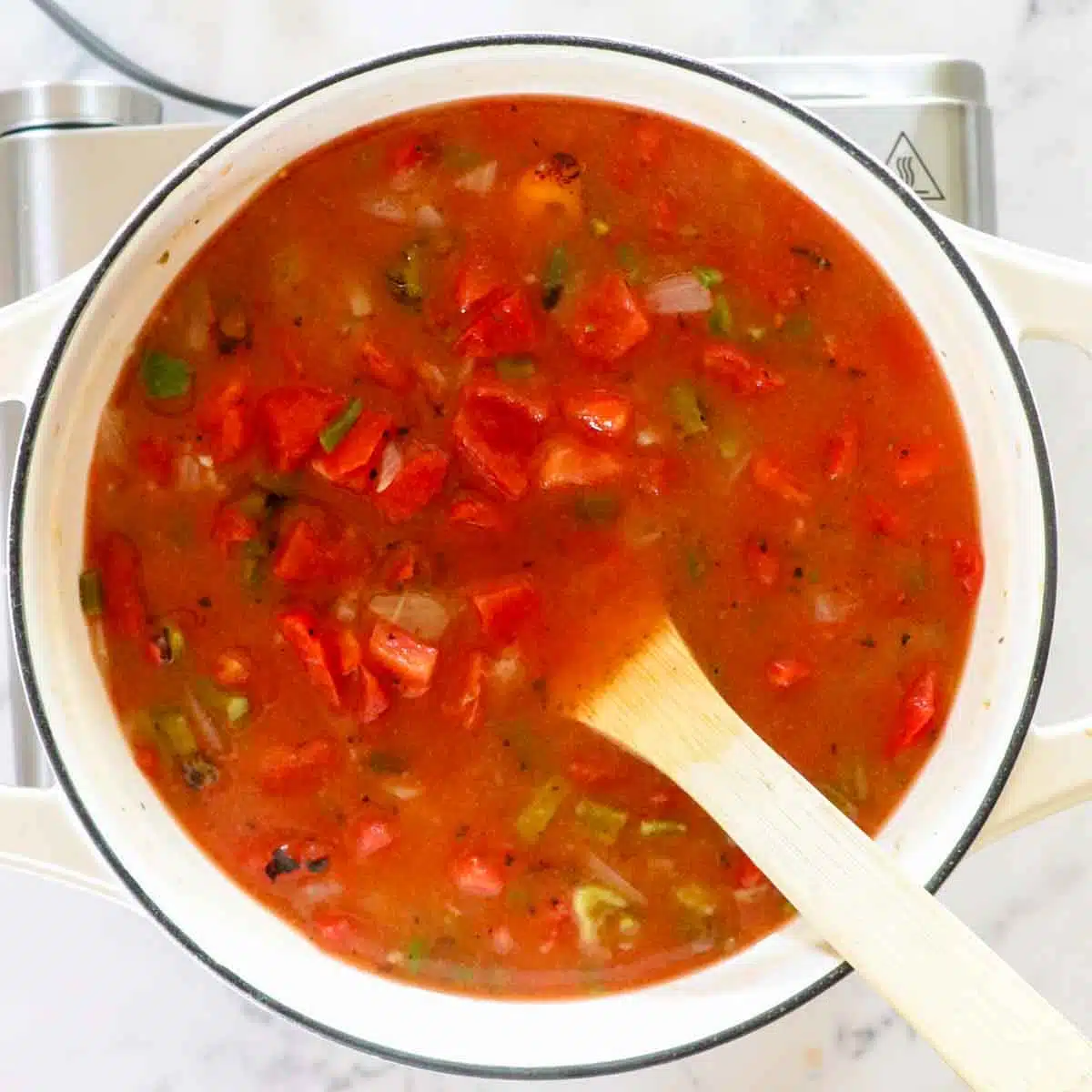 Green chile in a cast iron pot before the roux has been mixed in.
