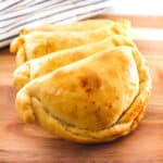 Four empanadas on a plate.