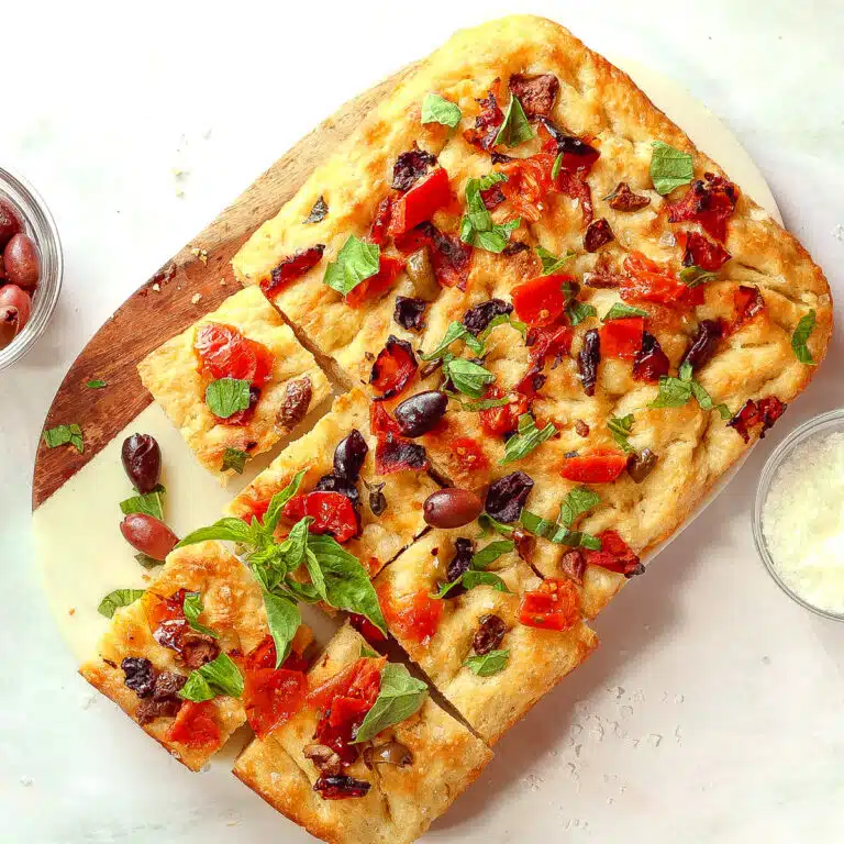 Tomato and olive focaccia cut into squares.