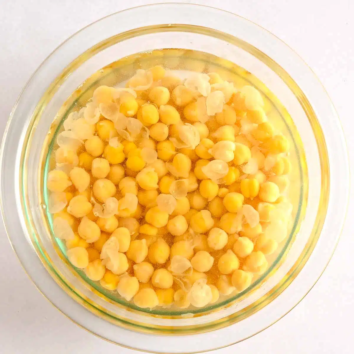 Chickpeas soaking in a bowl of water.