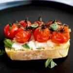 Air fryer cherry tomatoes on a the vine roasted on top of toast.