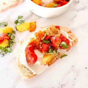 Roasted tomatoes on toast with whipped cream cheese.