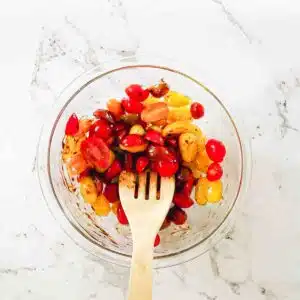 Tomato halves in a bowl with marinate.