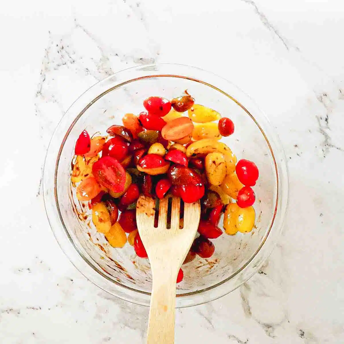Tomato halves in a bowl with marinate.
