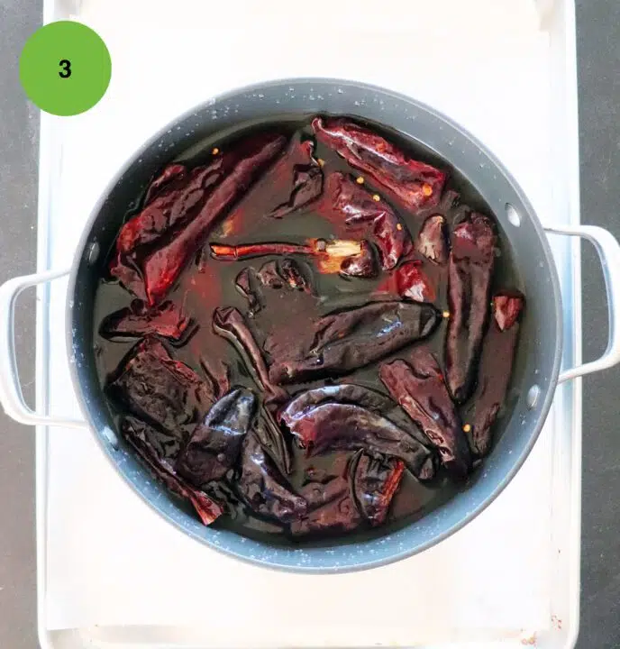 A pot of soaking chiles.