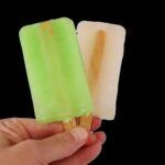 A hand two popsicles.