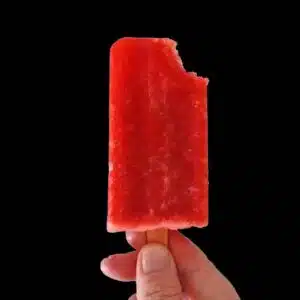 Hand holding popsicle.
