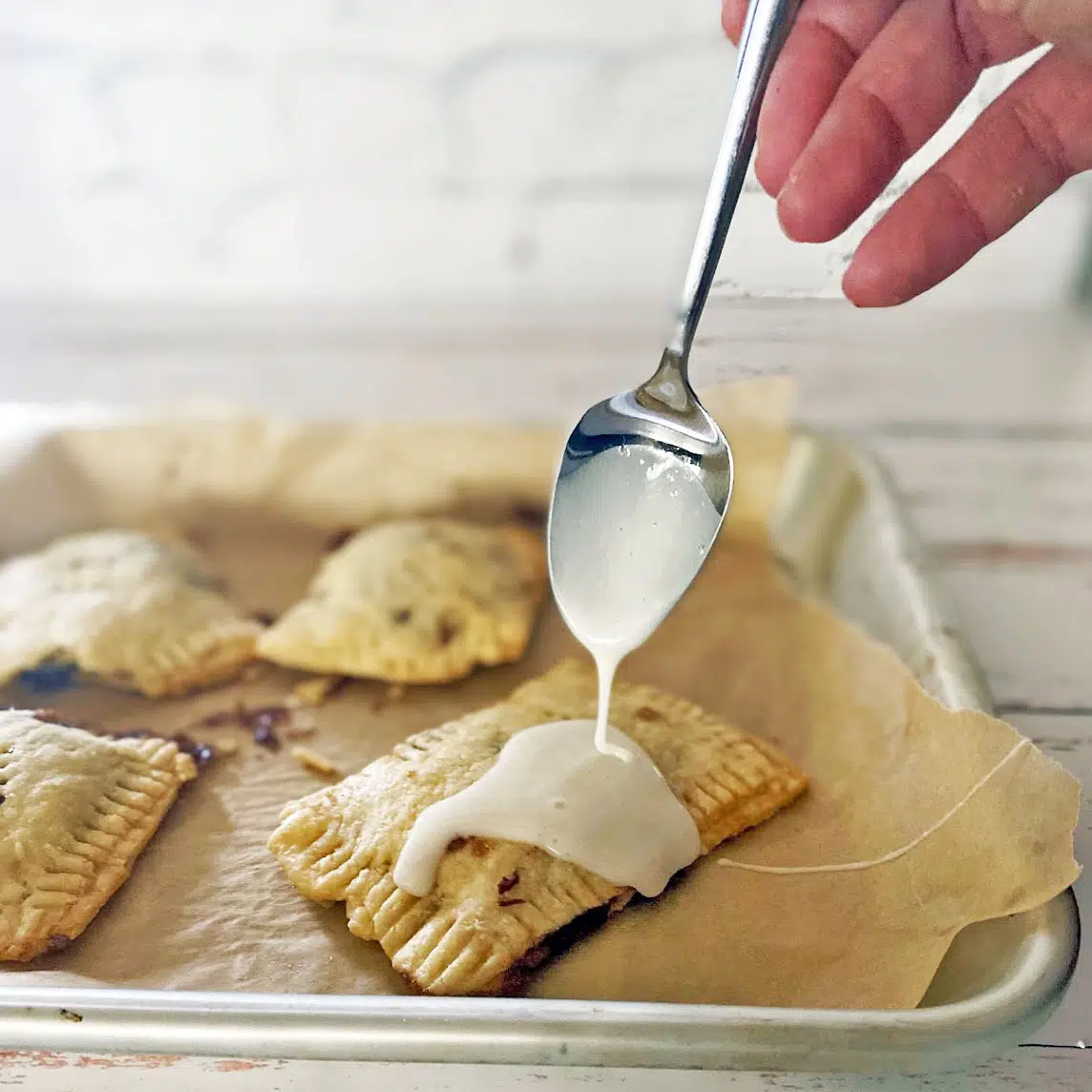 Dripping icing on to baked pastry.