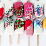 Two rows of decorated cake popsicles.