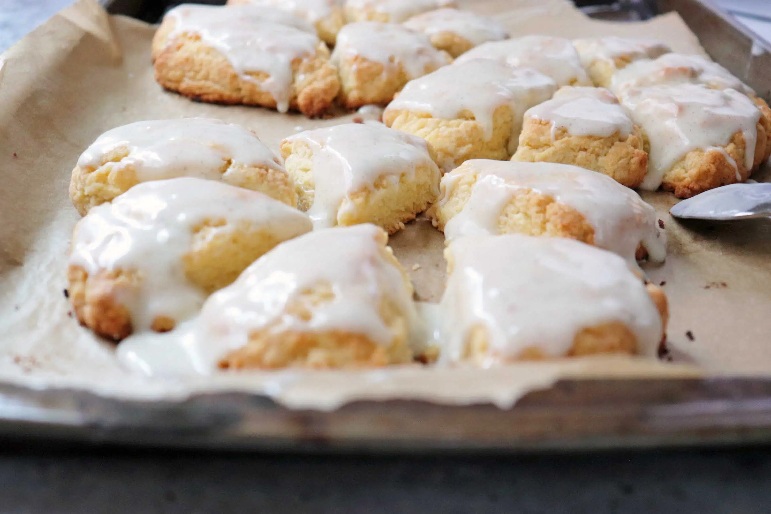 Baked and glazed scones on cookie sheet