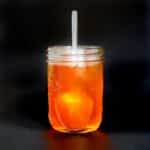 A mason jar filled with vegan apple honey.