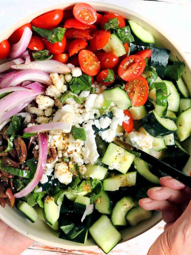 Finished salad with a fork in the bowl.