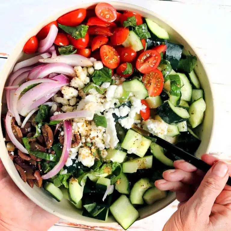 Finished salad with a fork in the bowl.