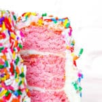 Three tiered vegan strawberry cake up close.