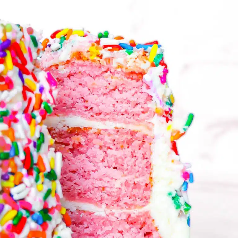 Three tiered vegan strawberry cake up close.
