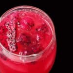 Picture of vibrant drink against a black background.