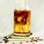 Pouring oatmilk into an apple crisp macchiato.