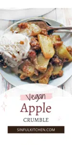 Vegan apple crumble on a plate with vanilla ice cream.