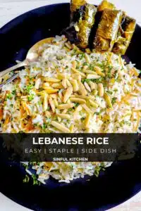 Rice on a plate garnished with pine nuts and grape leaves.