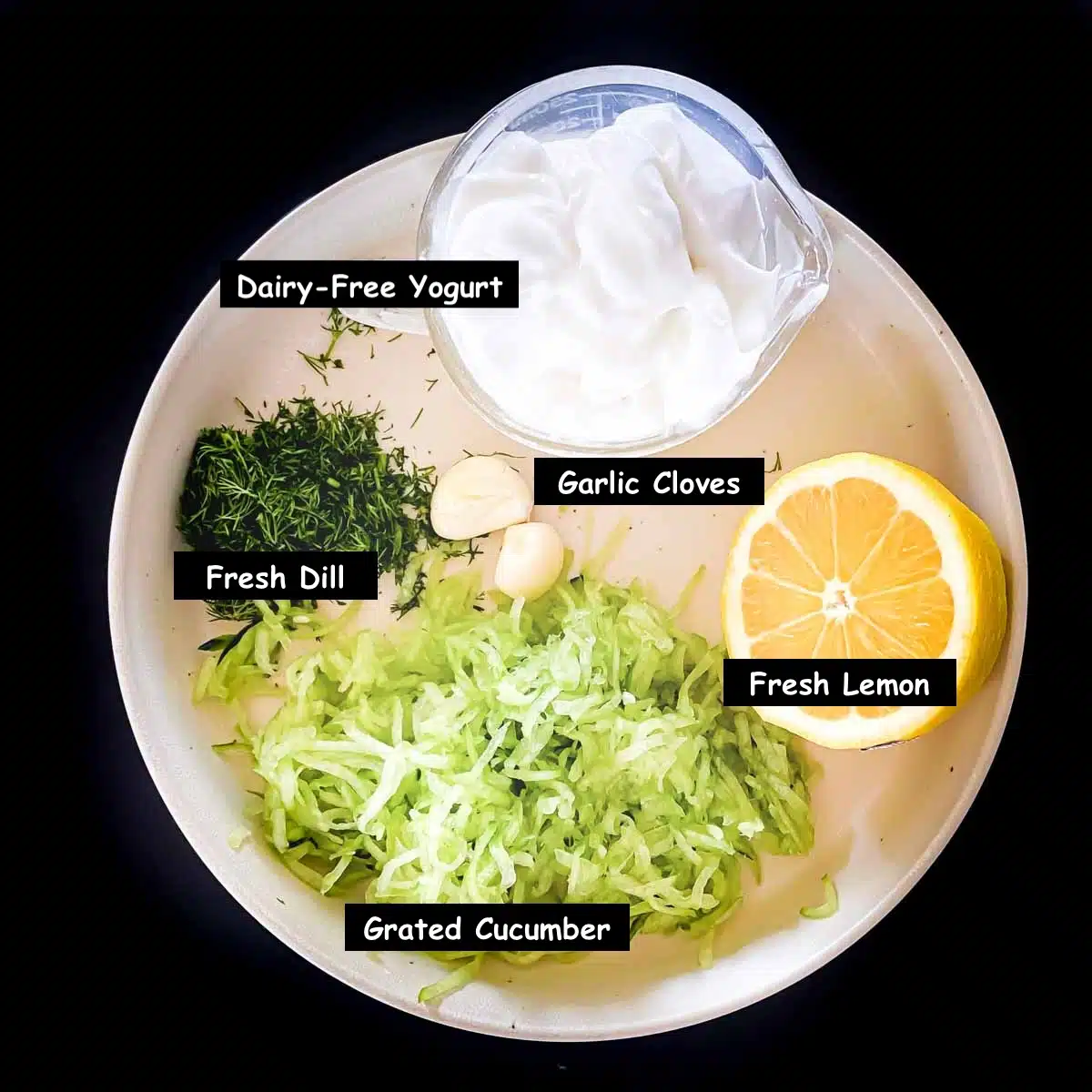 Ingredients used in making this recipe: vegan yogurt, lemon, garlic cloves, grated cucumber, and fresh dill. 