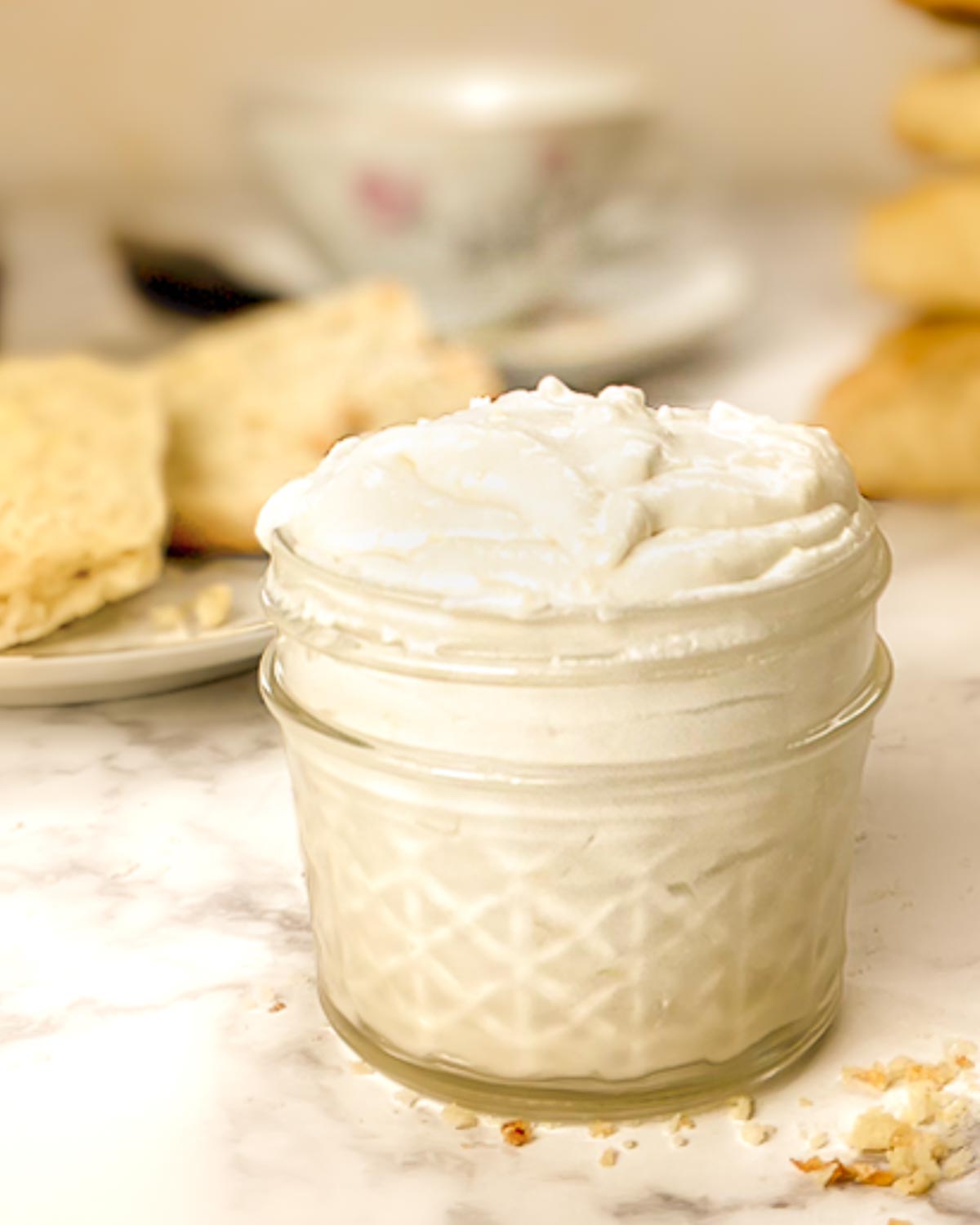 A jelly jar filed with vegan clotted cream.