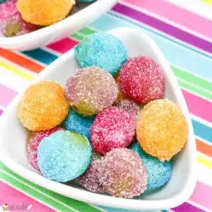 A bowl filled with rainbow grapes.