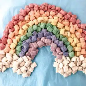 Puppy chow arranged in a rainbow.