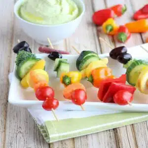 Food on kabobs organized in the colors of the rainbow.