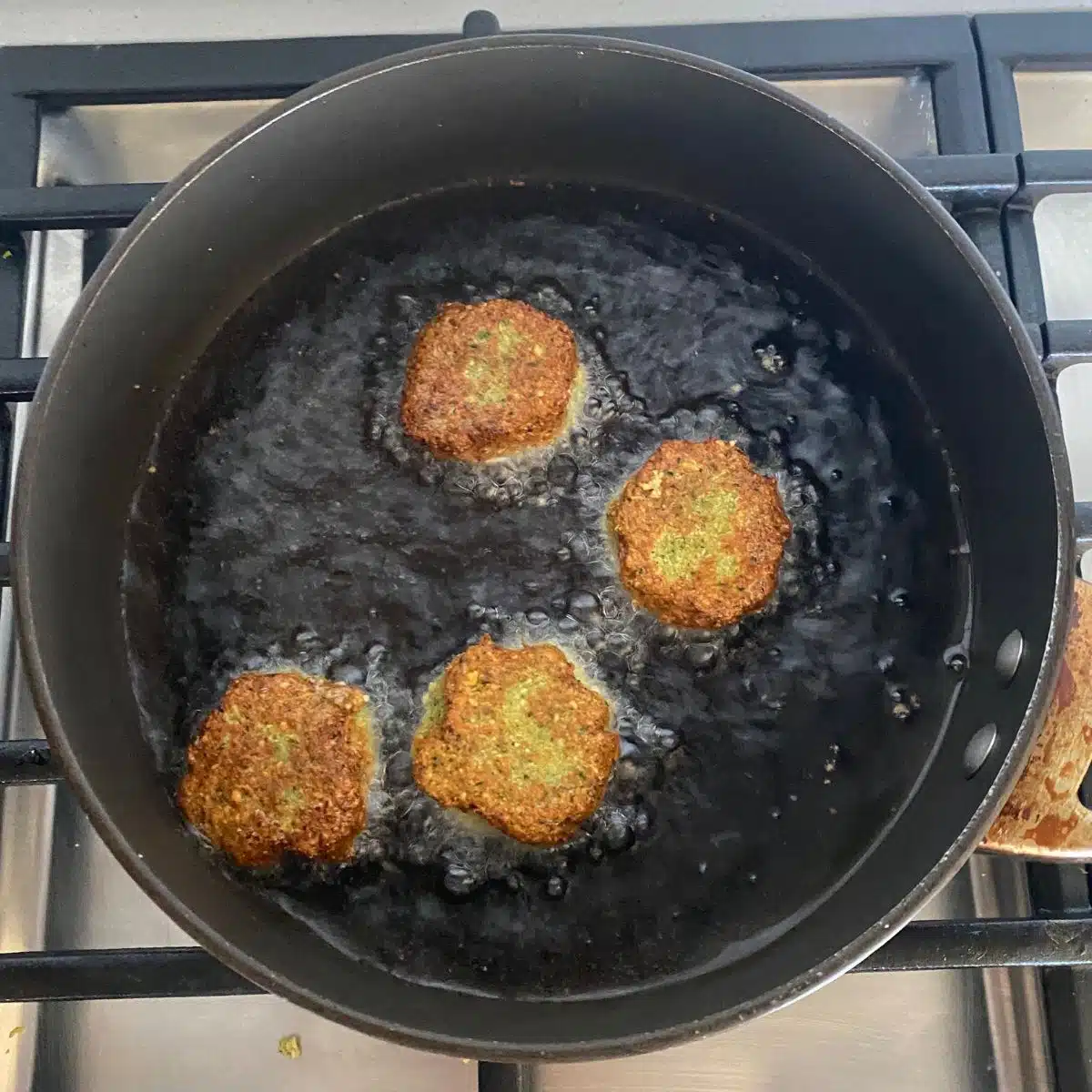 Falafel patties almost done frying.