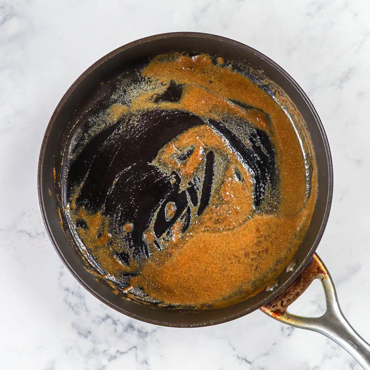Spices bloomed in a skillet. 