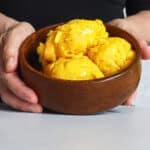Hands cupping a bowl of sorbet.
