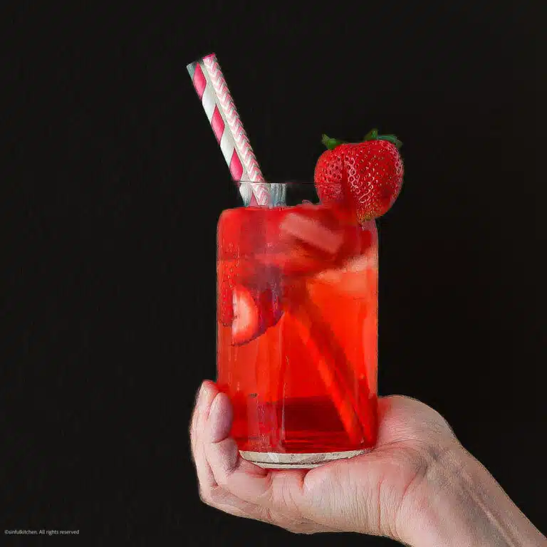 Hand holding strawberry acai refresher.