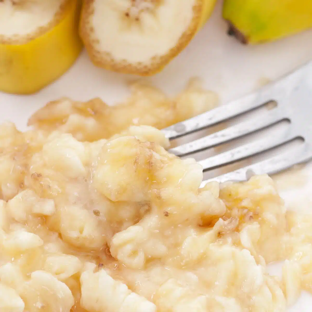 Fork mashing banana.