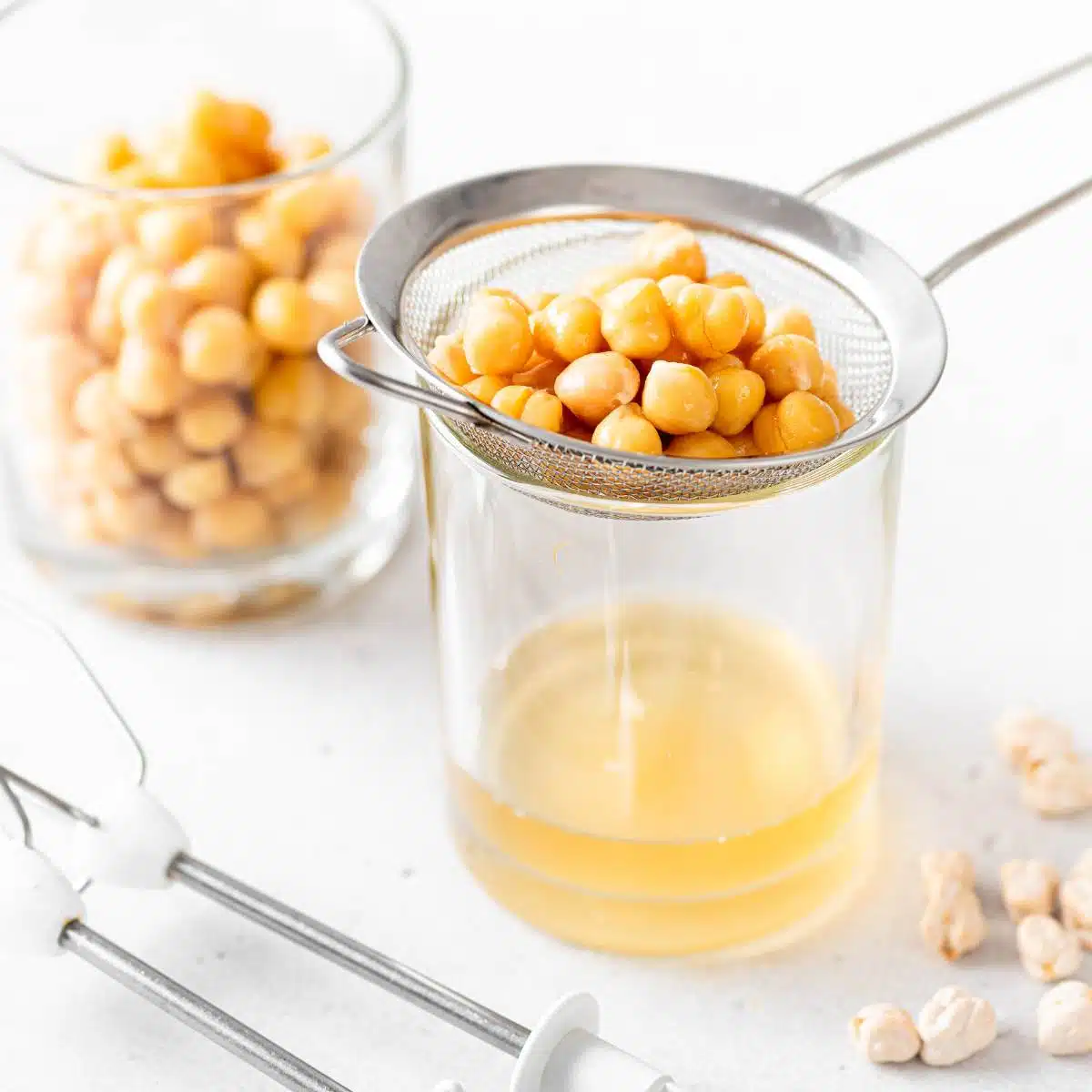 Aquafaba being strained from garbanzo beans.