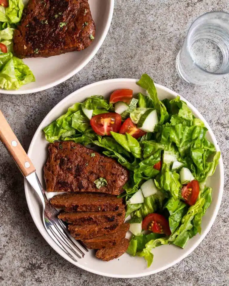 Steak on a plate with salad.