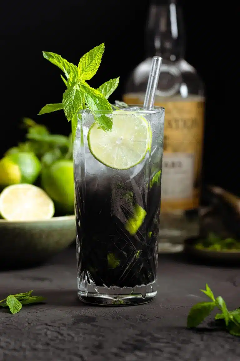 Garnished black mojito.