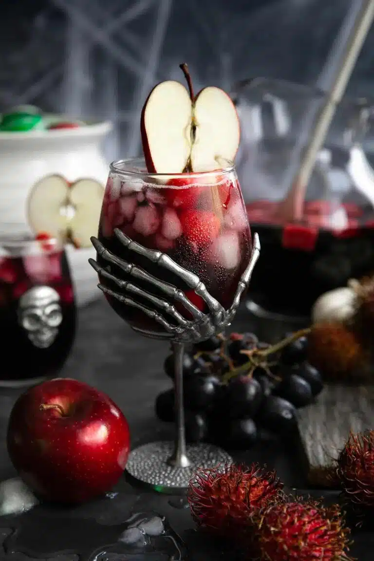 Spooky cocktail with skelton hands holding the glass. 