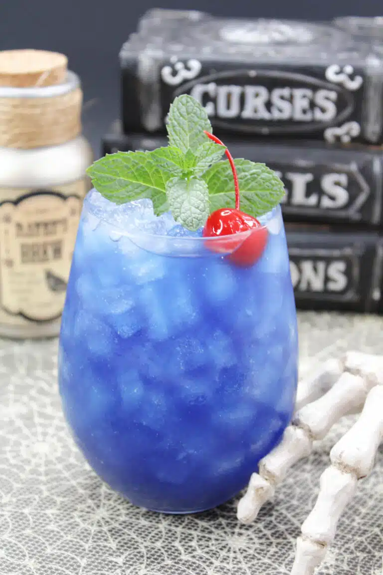 Blue cocktail with a cherry.