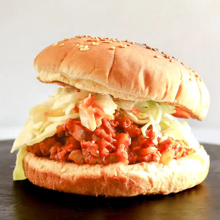 Sloppy Joe on a bun with coleslaw.
