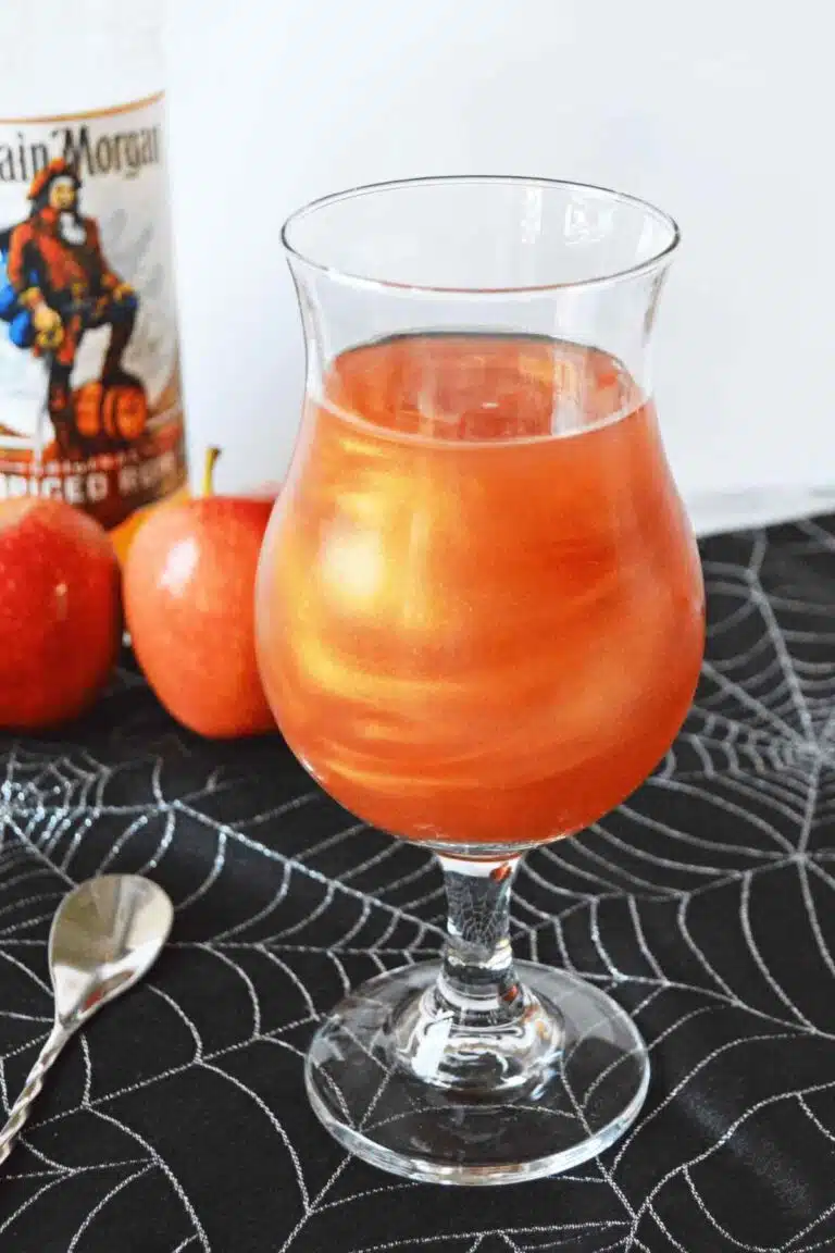 Shimmery orange cocktail on a spiderweb napkin. 