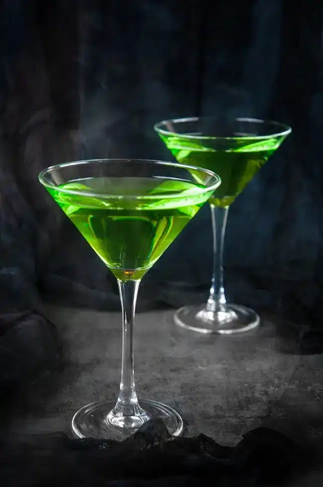 Two bright green cocktail sin a martini glasses. 