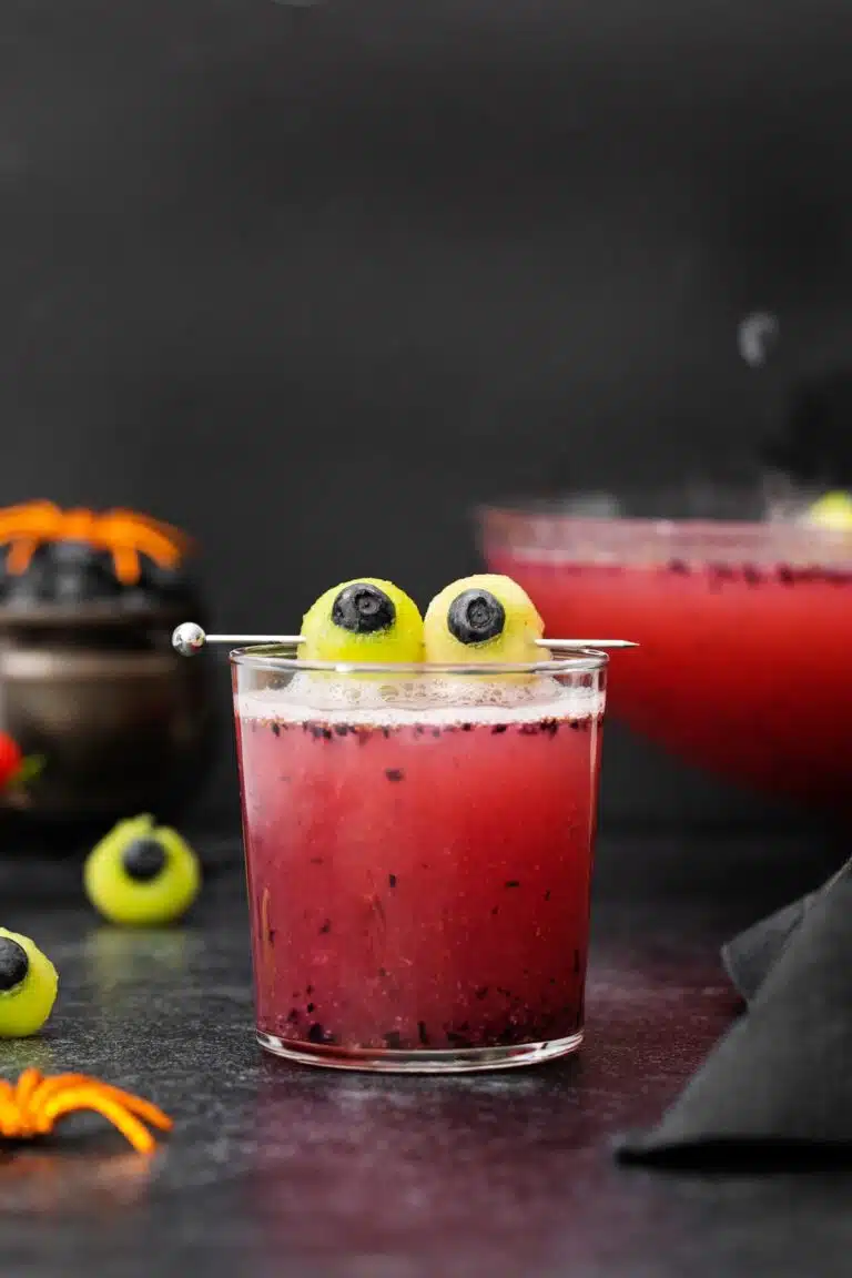 Glass filled with punch and garnished with two yellow eyes.