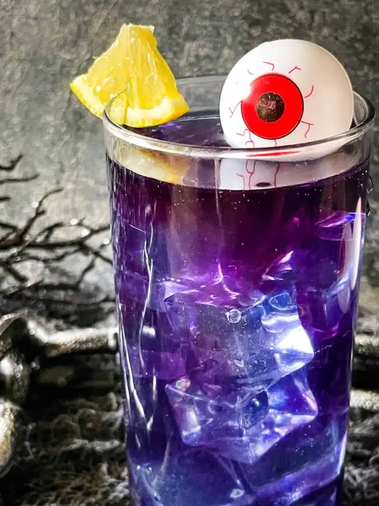 Purple cocktail/mocktail with a creepy eye floating in it. 