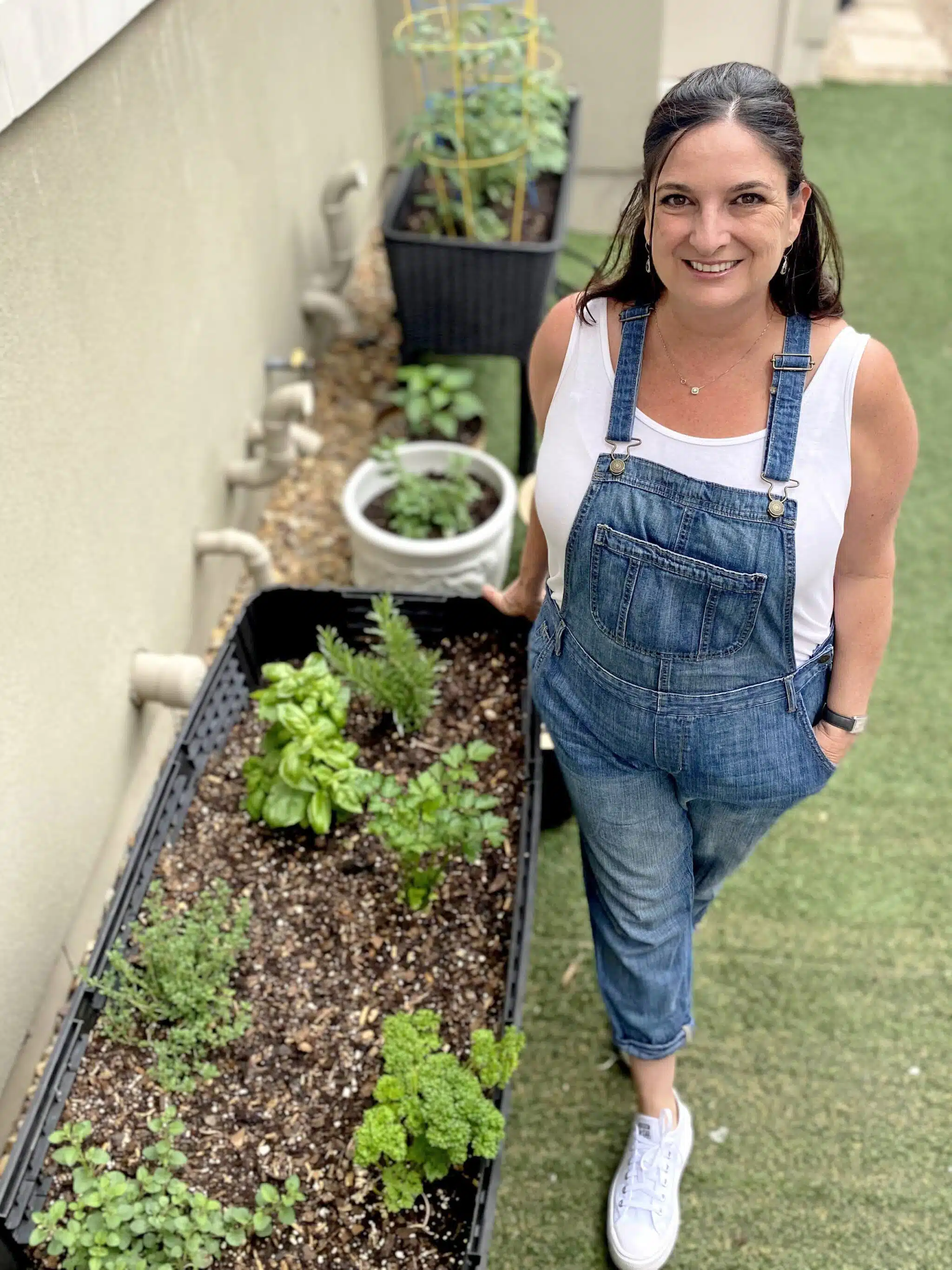 Ruth standing next to her small garden.