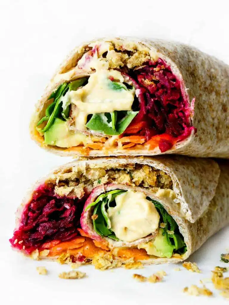 A falafel wrap cut in half and stacked on top of each other. 