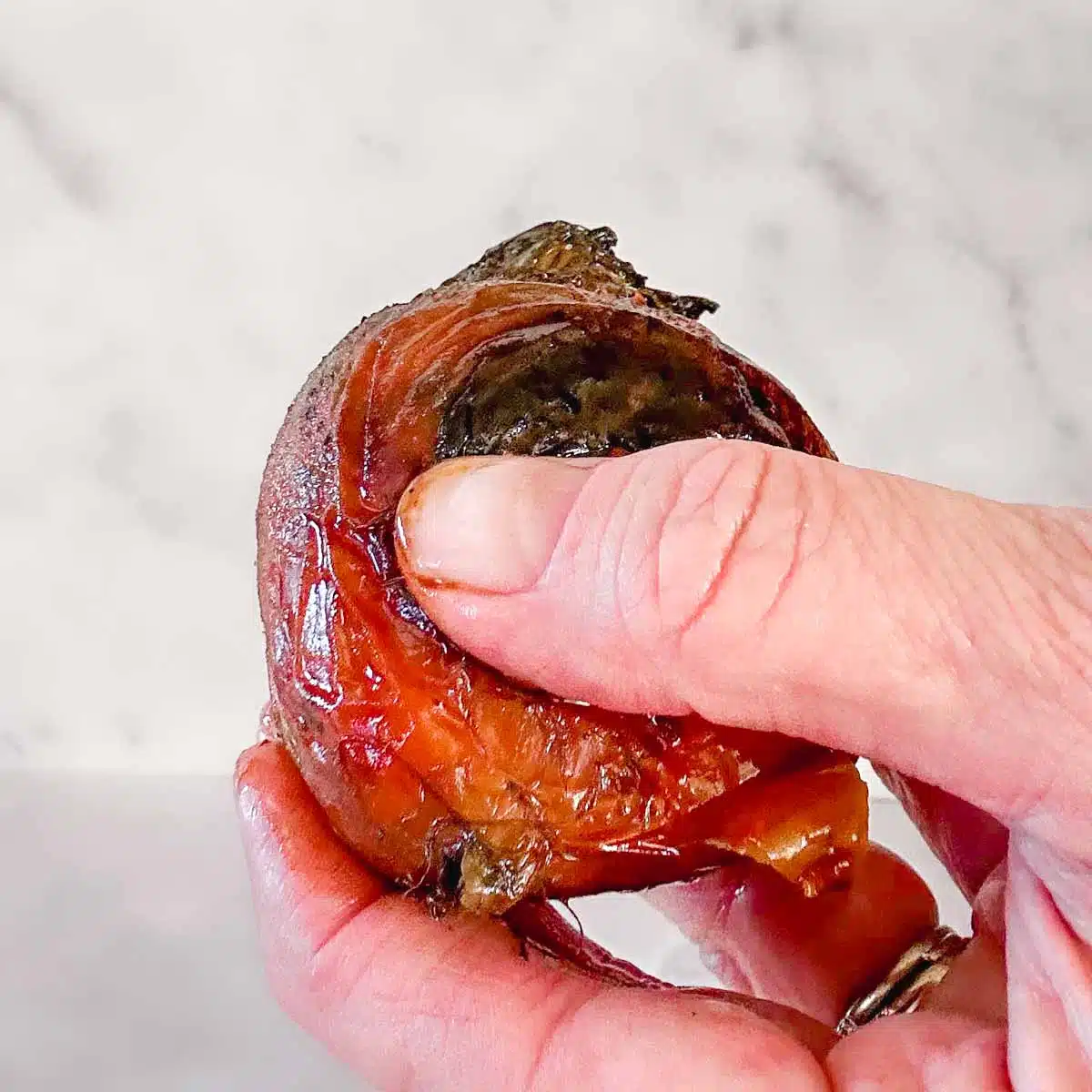 Rubbing the skin off a cooked beet. 