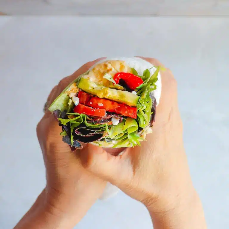 Two hands hold a wrap.