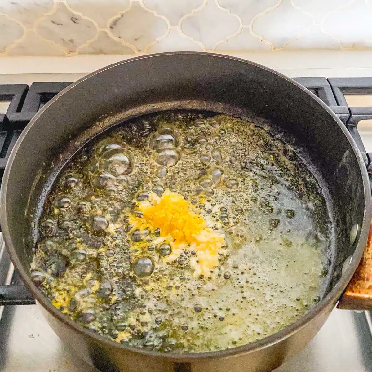 Lemon added to melted butter in a saucepan.
