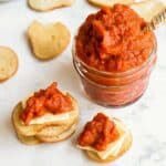 Ajvar in a small jar with toast and cheese.