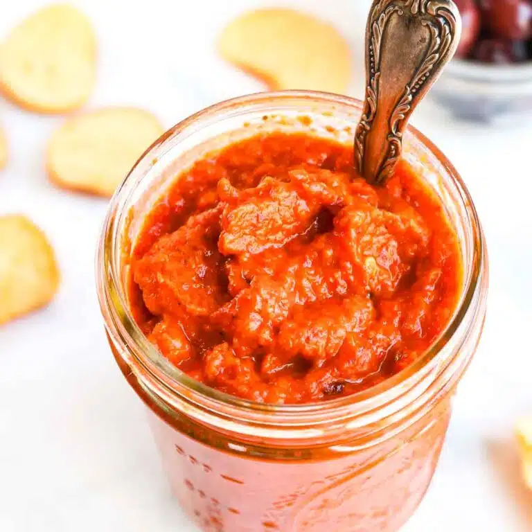Avjar in a mason jar with a spoon in the jar.